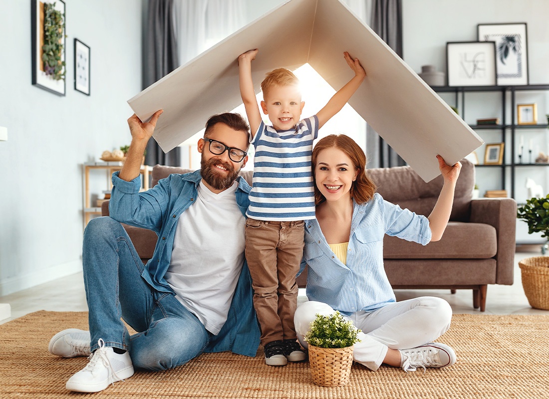 Personal Insurance - A Young Family Spending Time Together at Home in Their Living Room